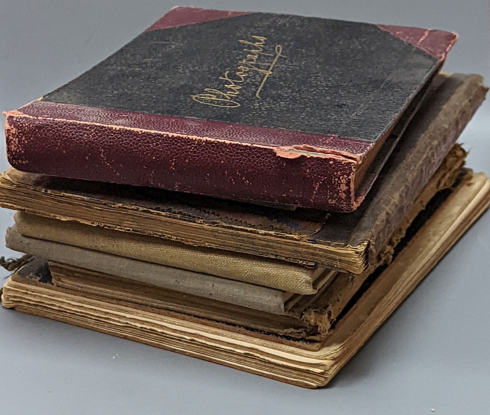 Five various sketch books, an exercise book containing miscellaneous crests and a photograph album